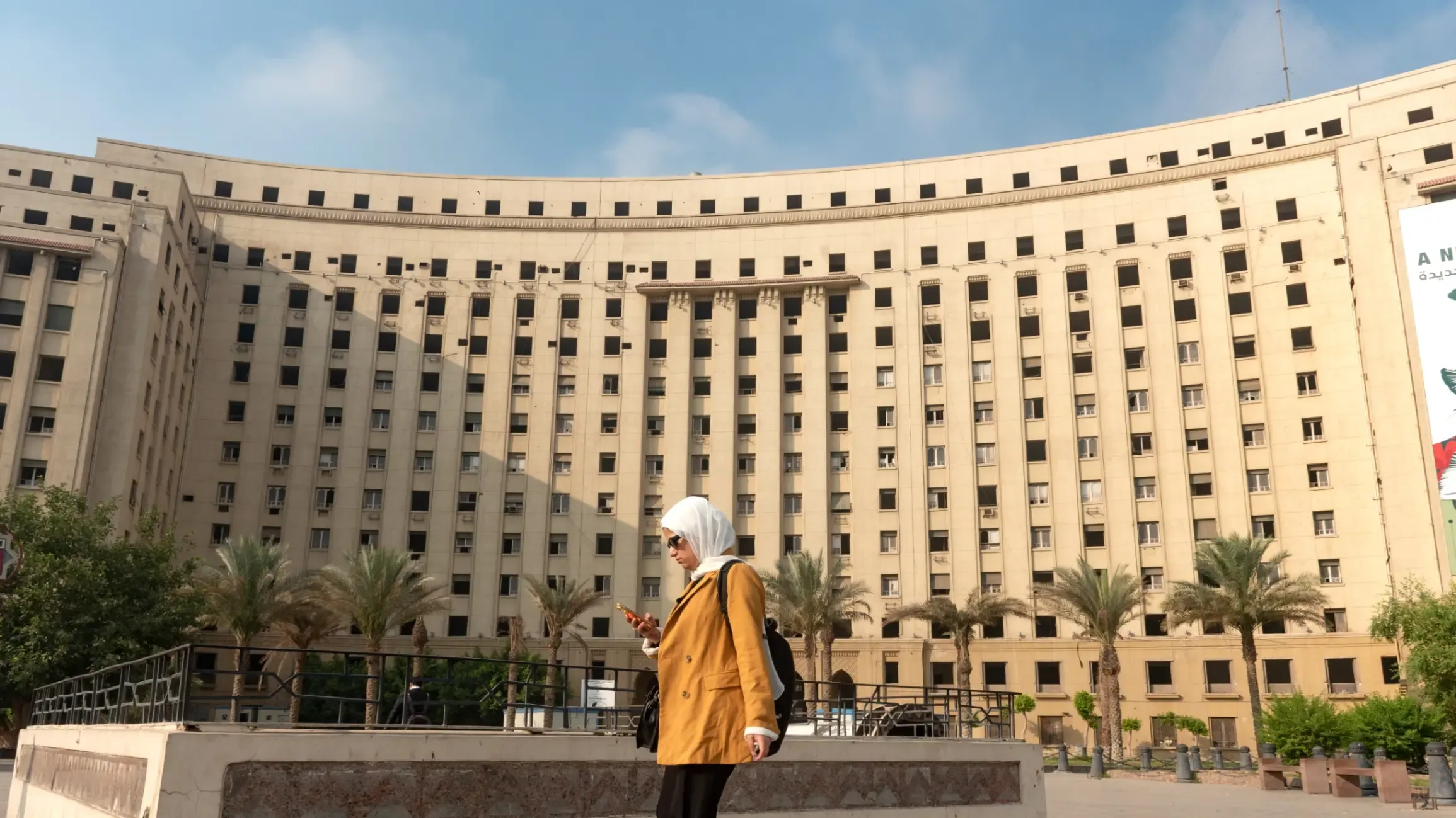 A woman walks in front of the historic Mogamma el-Tahrir building in Cairo, Egypt.